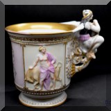 P26. Porcelain mug with figural handle. 